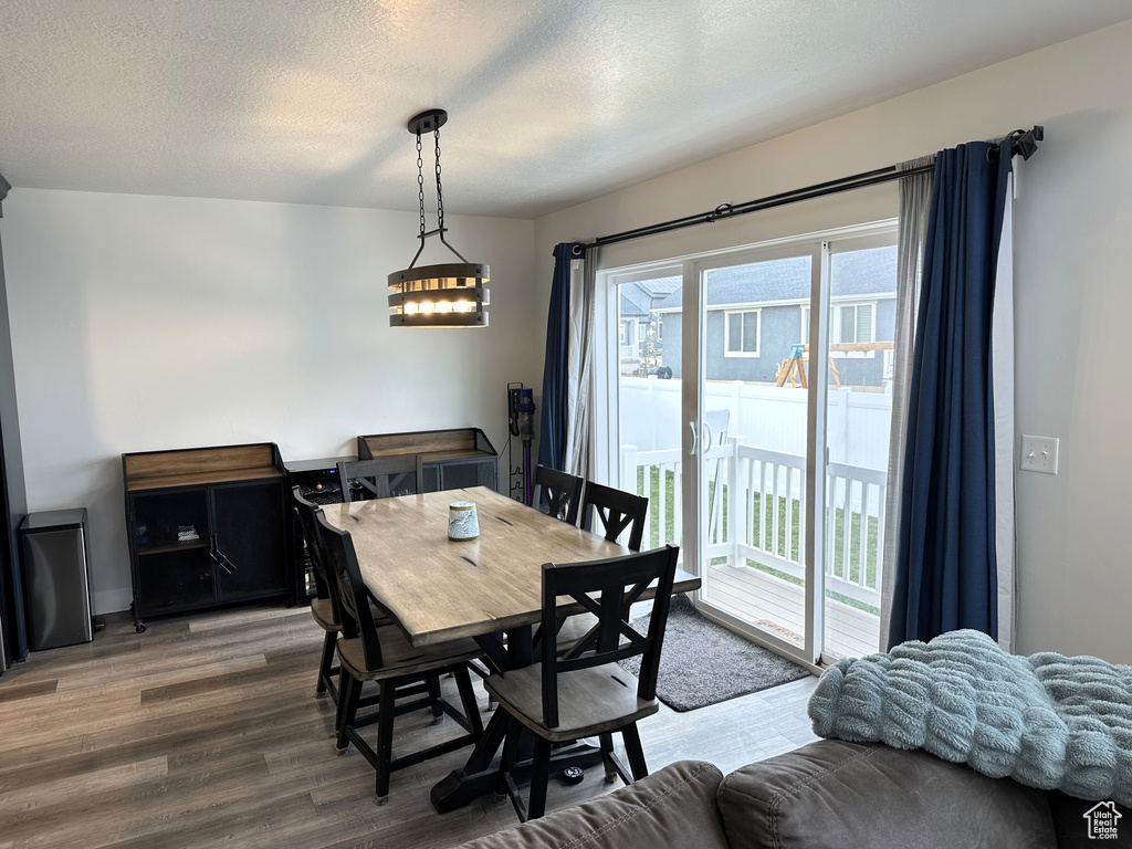 Dining room featuring wood finished floors and a textured ceiling