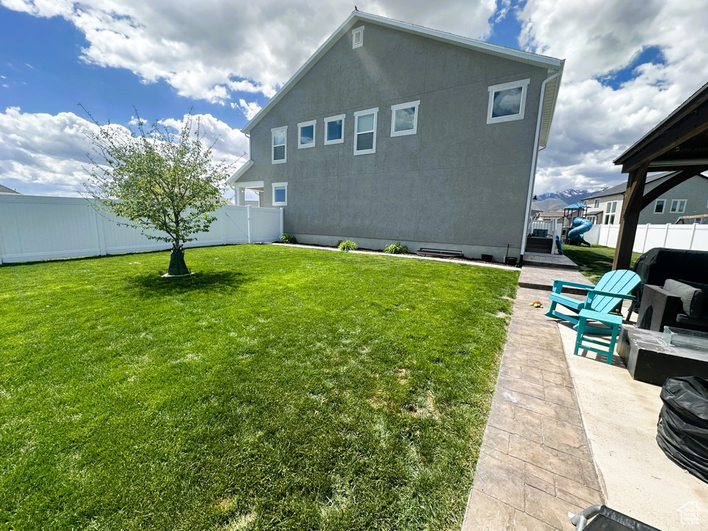 Rear view of property featuring a patio