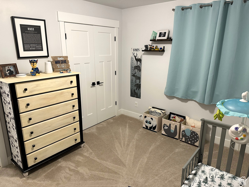 Bedroom featuring carpet flooring, baseboards, and a closet