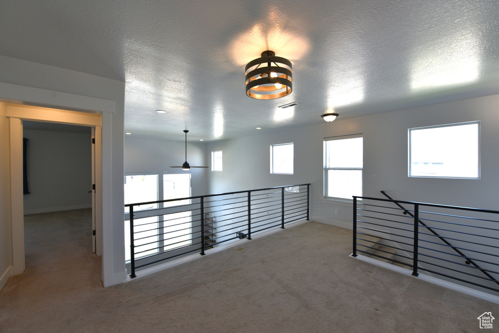 Unfurnished room with carpet floors and a textured ceiling