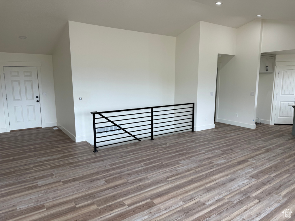 Spare room featuring wood finished floors, baseboards, and recessed lighting