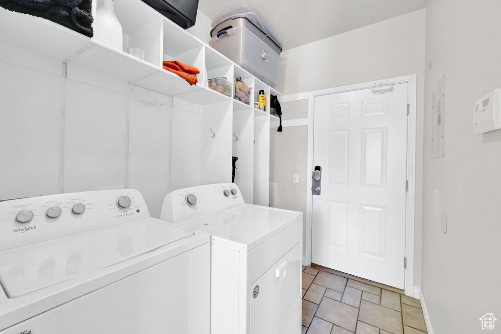 Clothes washing area with washer and clothes dryer and baseboards