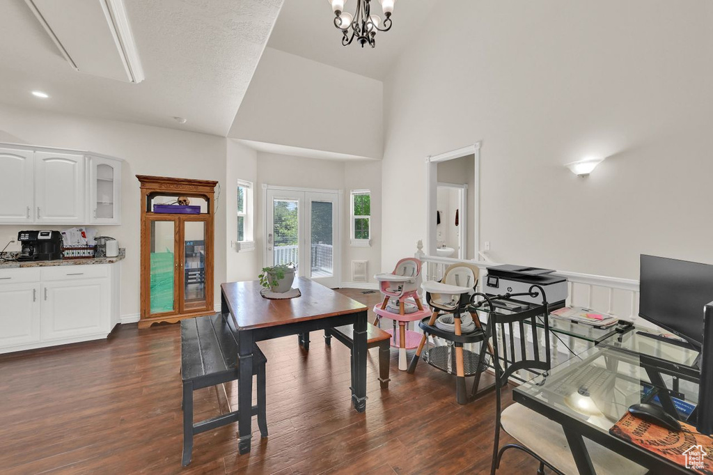 Dining area with dark wood-style floors and a chandelier