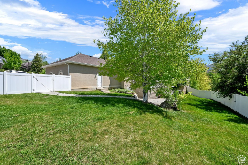 View of yard featuring a gate and entry steps