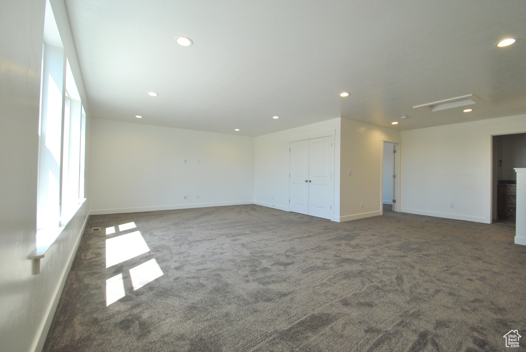 Empty room with carpet, healthy amount of natural light, recessed lighting, and baseboards