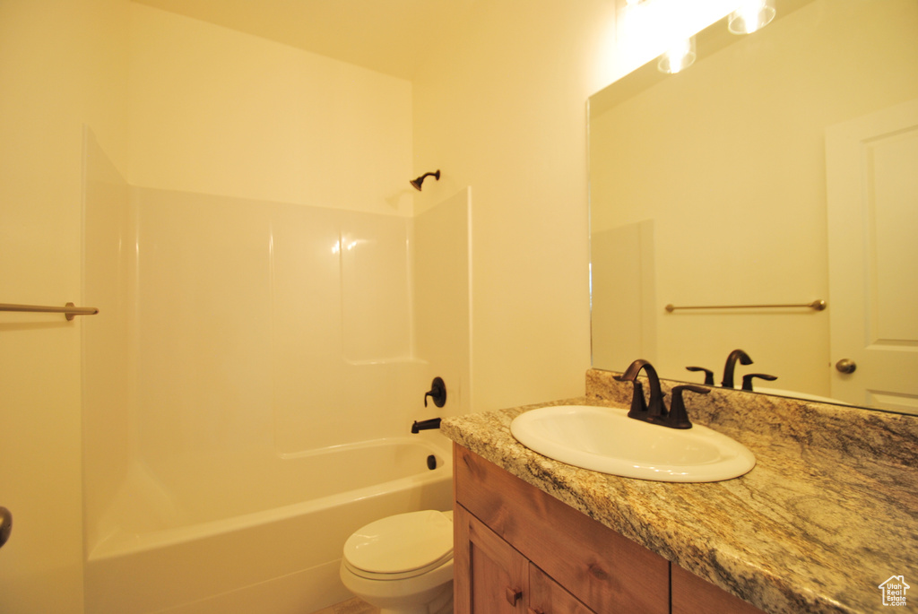 Full bathroom with shower / bathtub combination, toilet, and vanity