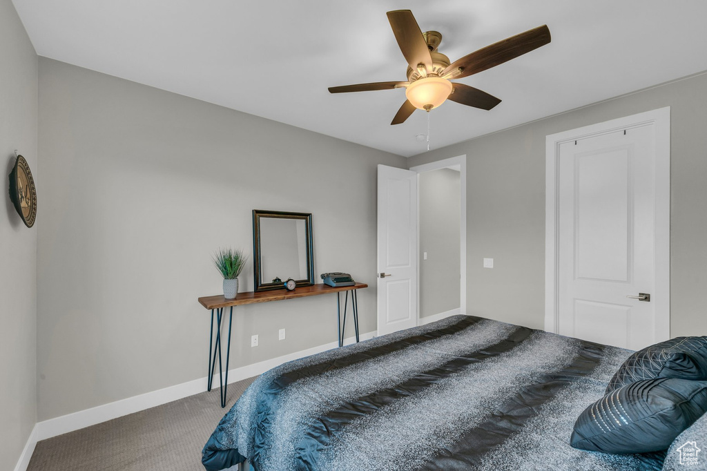 Bedroom featuring carpet, baseboards, and ceiling fan