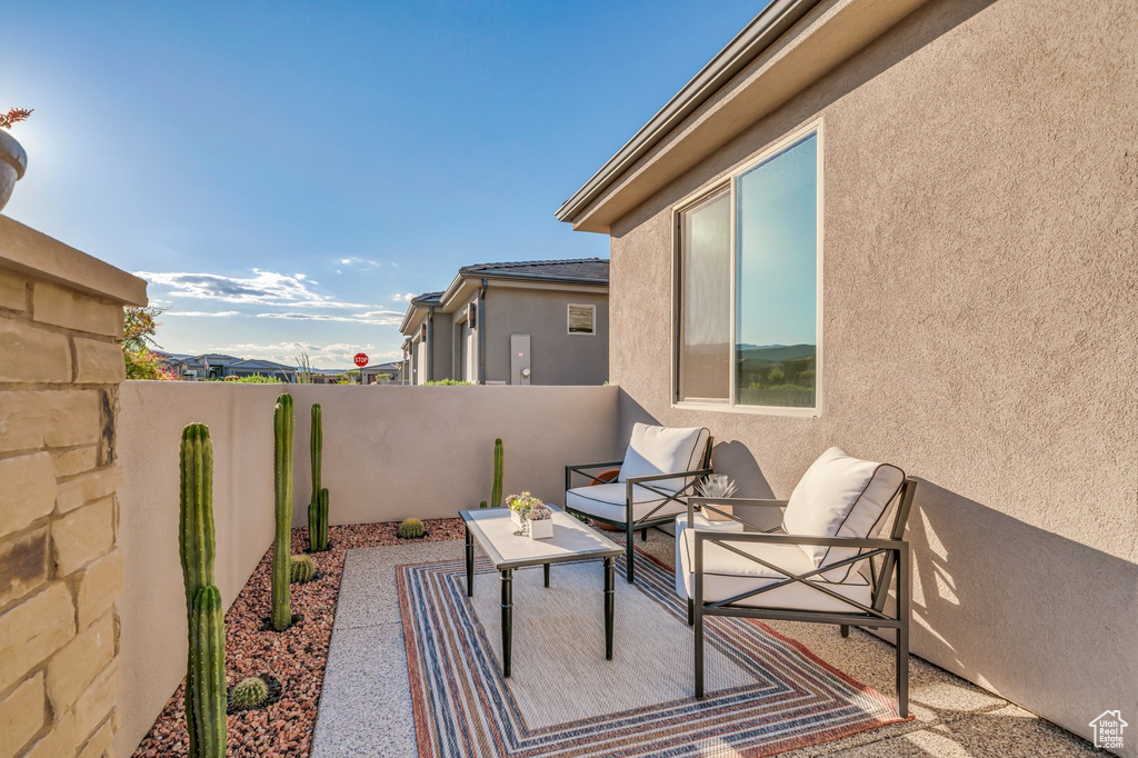 View of patio featuring fence