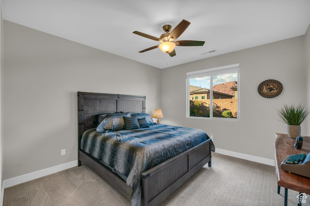 Bedroom with baseboards, carpet, and ceiling fan