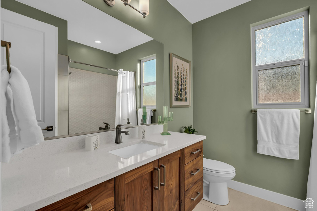 Full bathroom with a shower with curtain, toilet, tile patterned floors, vanity, and baseboards