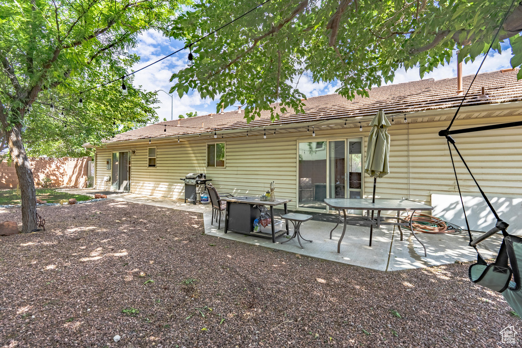 Rear view of property with fence and a patio area