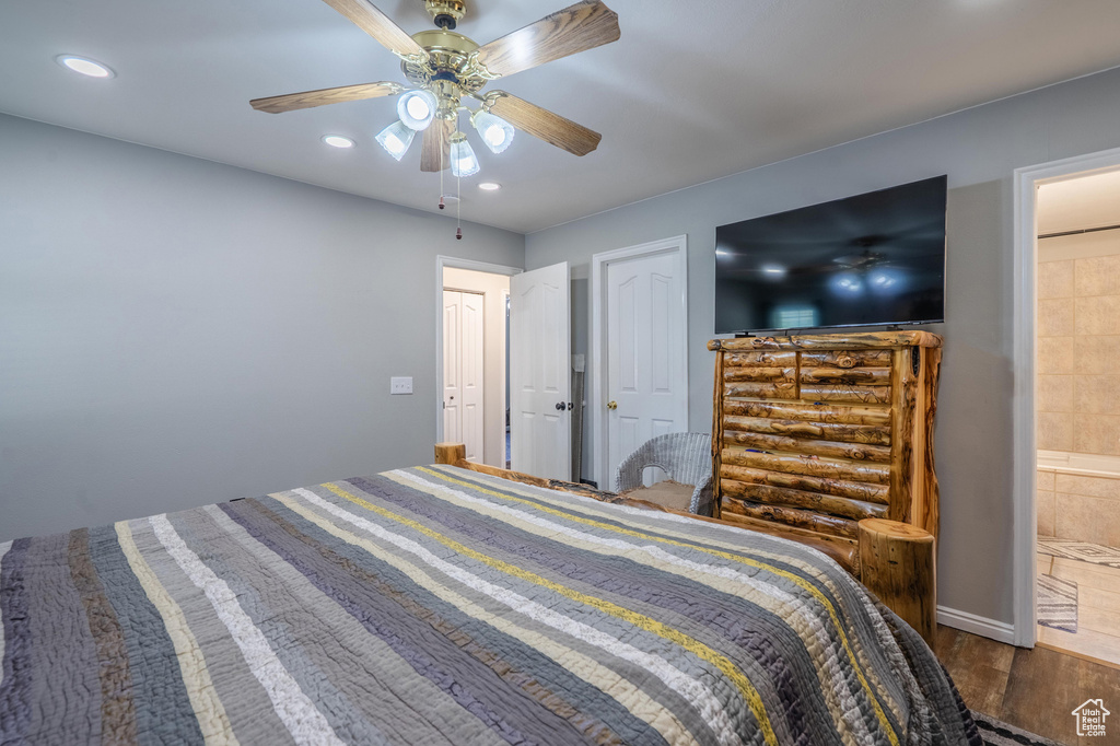 Bedroom featuring wood finished floors, ceiling fan, recessed lighting, and ensuite bathroom