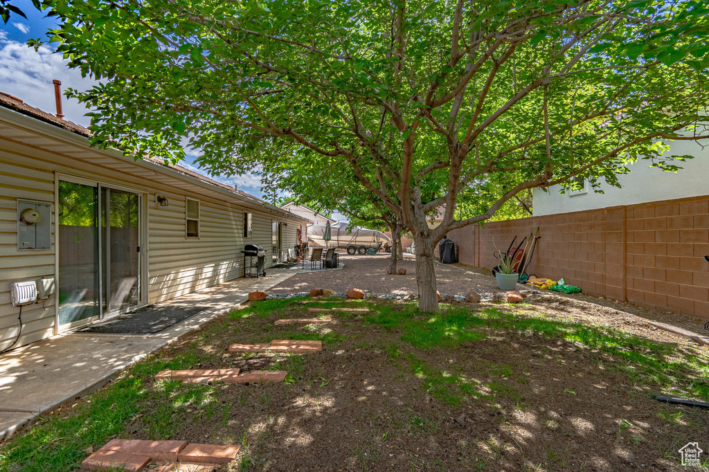 Fenced backyard with a patio