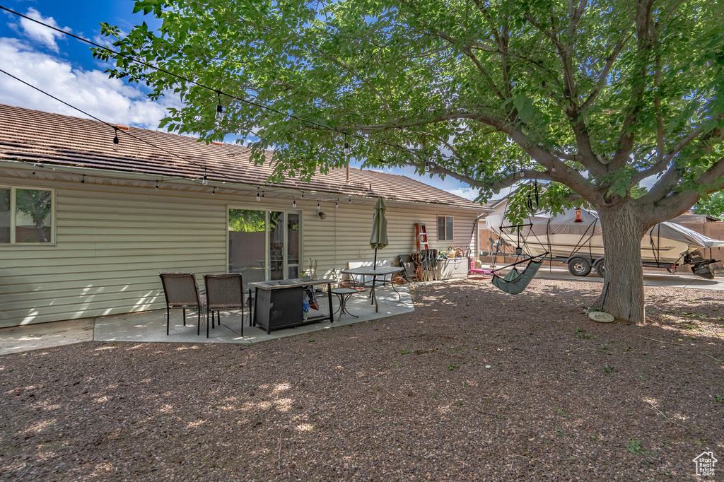 Back of house featuring a patio and a tiled roof