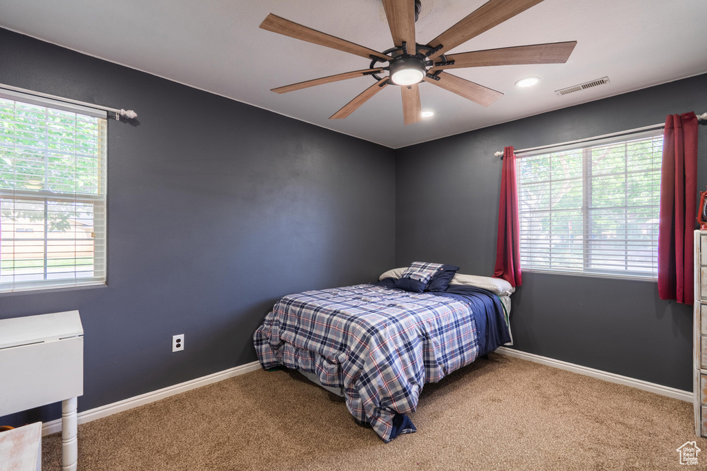 Bedroom with multiple windows, carpet, baseboards, a ceiling fan, and recessed lighting