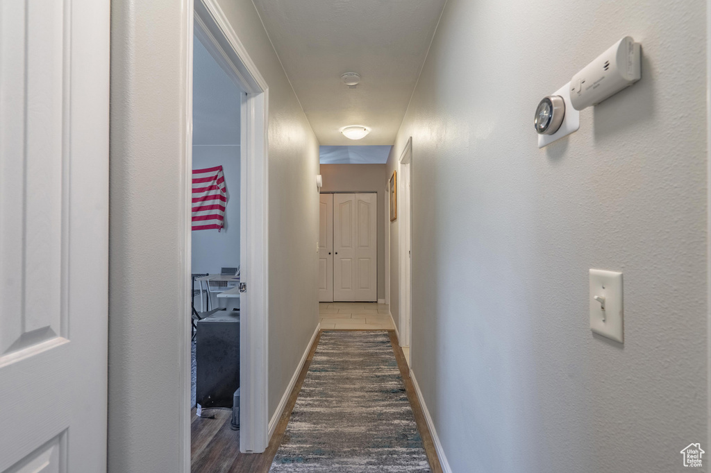 Corridor featuring baseboards