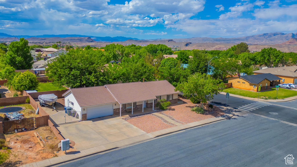 Aerial view of property and surrounding area with a mountain backdrop