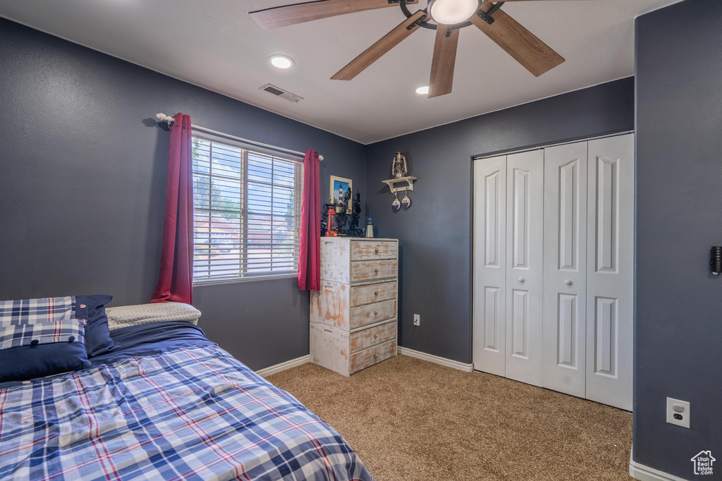 Carpeted bedroom with a closet, a ceiling fan, baseboards, and recessed lighting