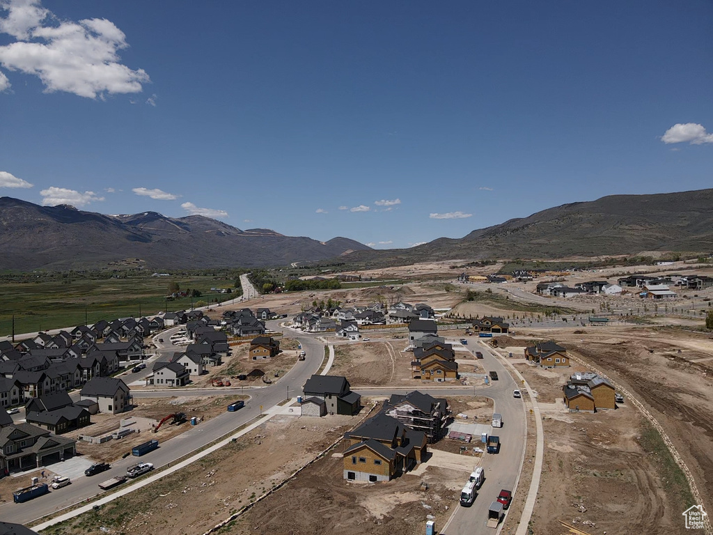 Aerial view of property's location with mountains and nearby suburban area