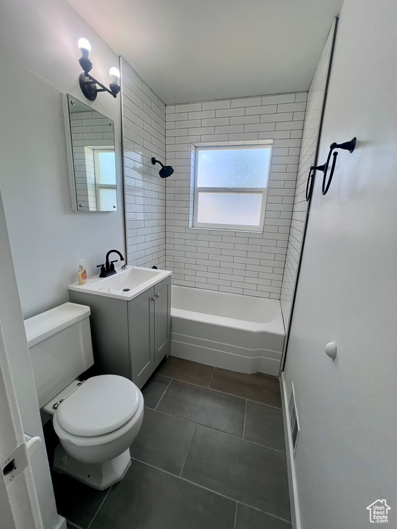 Full bathroom with tile patterned flooring, toilet,  shower combination, and vanity