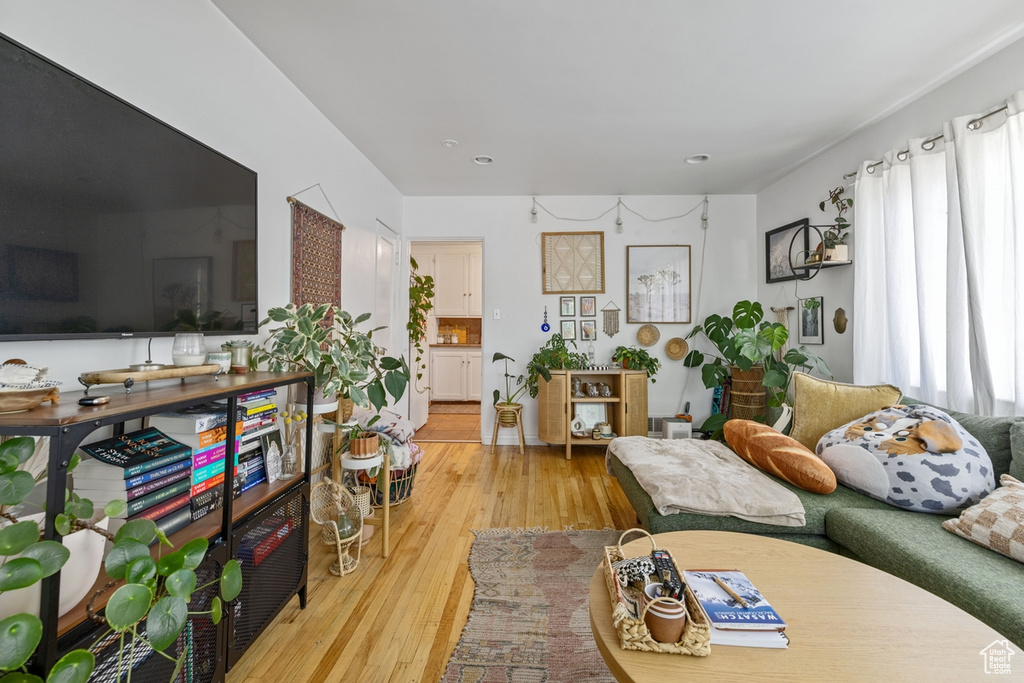 Living room featuring light wood finished floors and recessed lighting