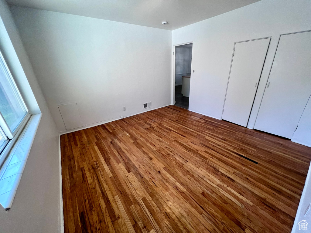 Unfurnished bedroom with hardwood / wood-style floors