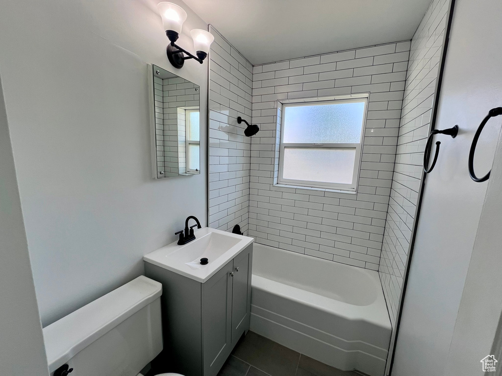 Bathroom featuring toilet, tile patterned flooring, bathtub / shower combination, and vanity