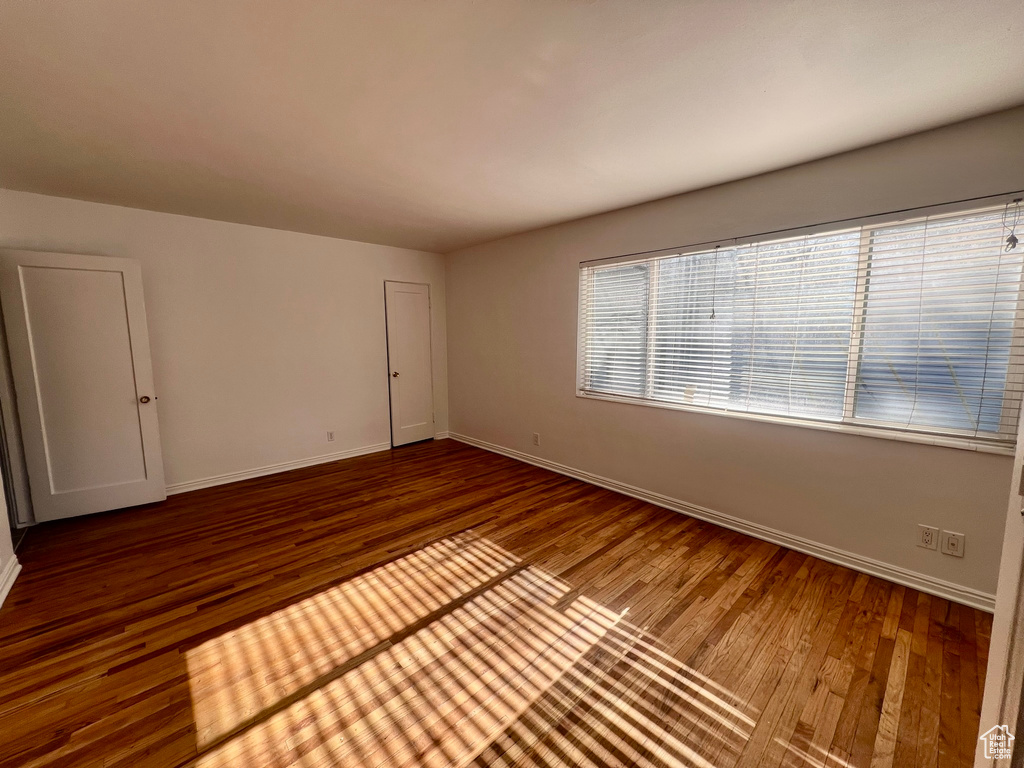 Unfurnished room featuring wood finished floors and baseboards