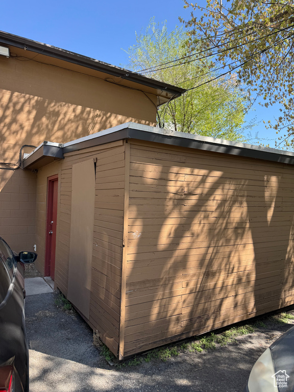 View of side of property featuring an outbuilding