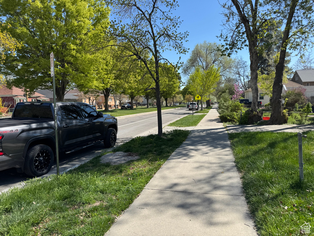 View of asphalt street featuring sidewalks