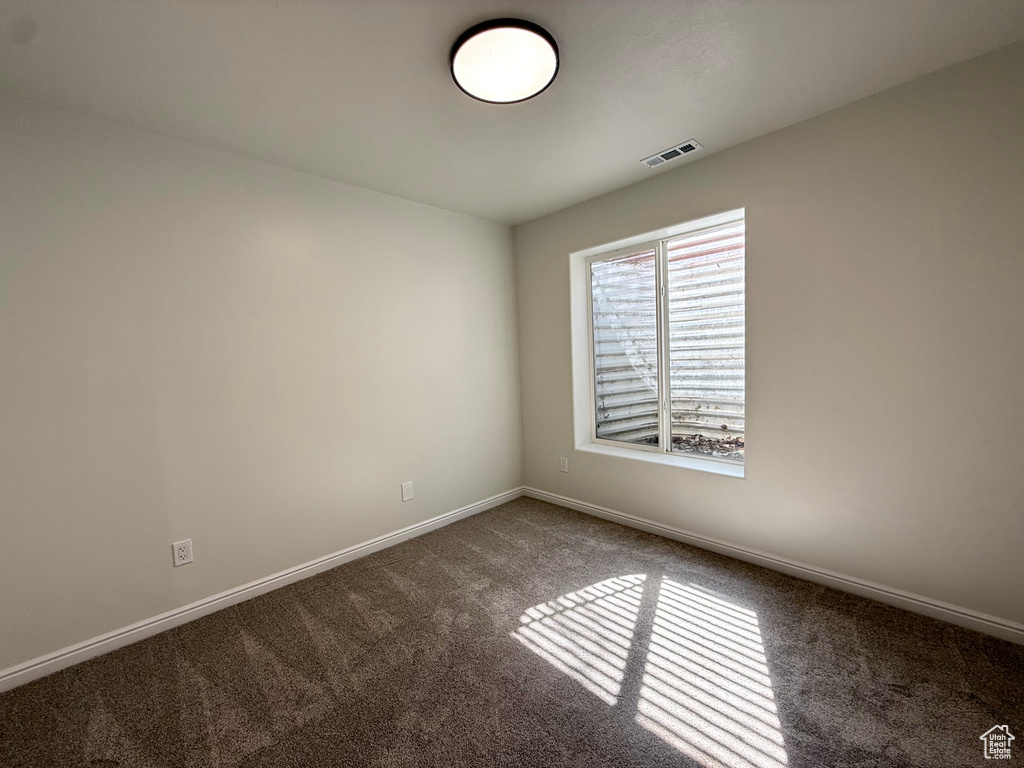 Unfurnished room featuring carpet floors and baseboards