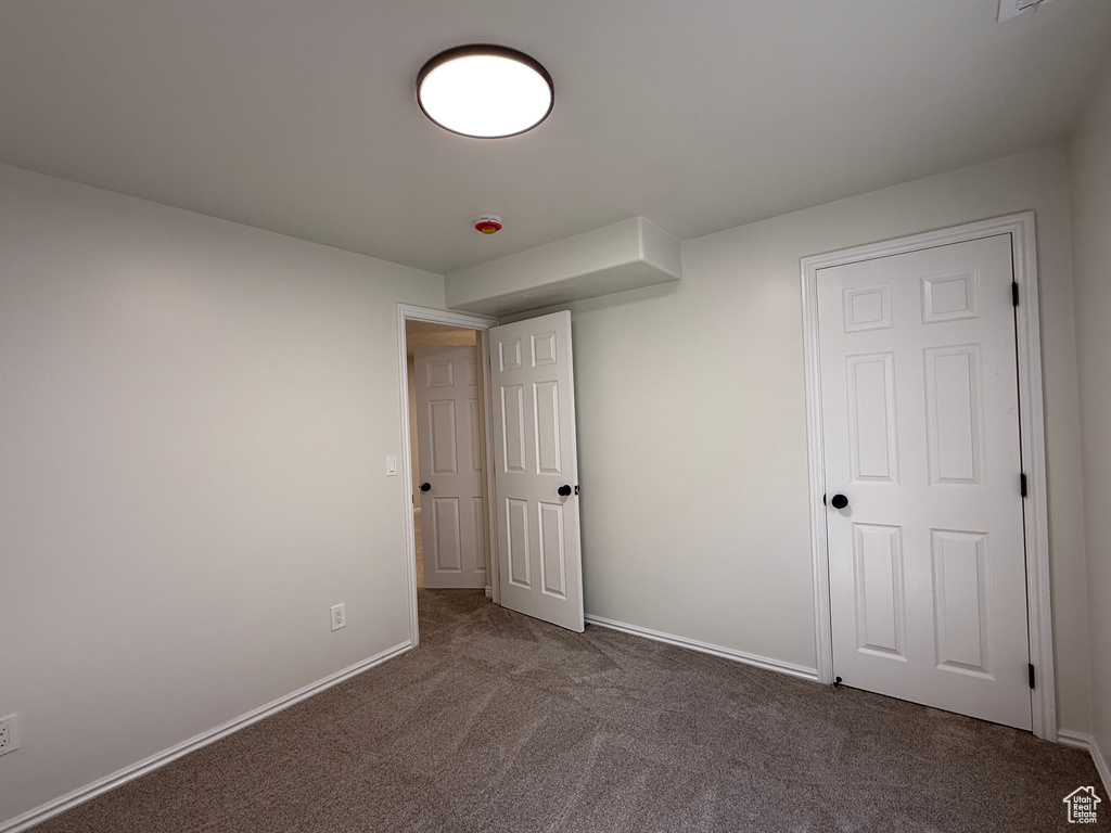 Unfurnished bedroom featuring carpet floors and baseboards