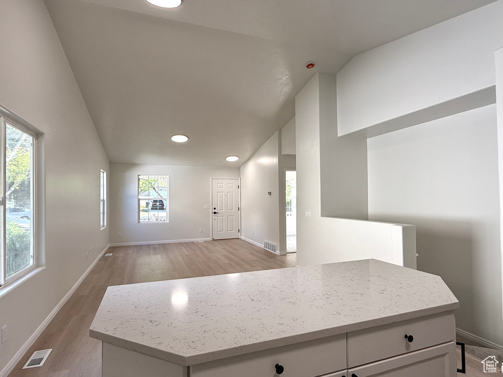 Foyer entrance with light wood finished floors, baseboards, lofted ceiling, and recessed lighting