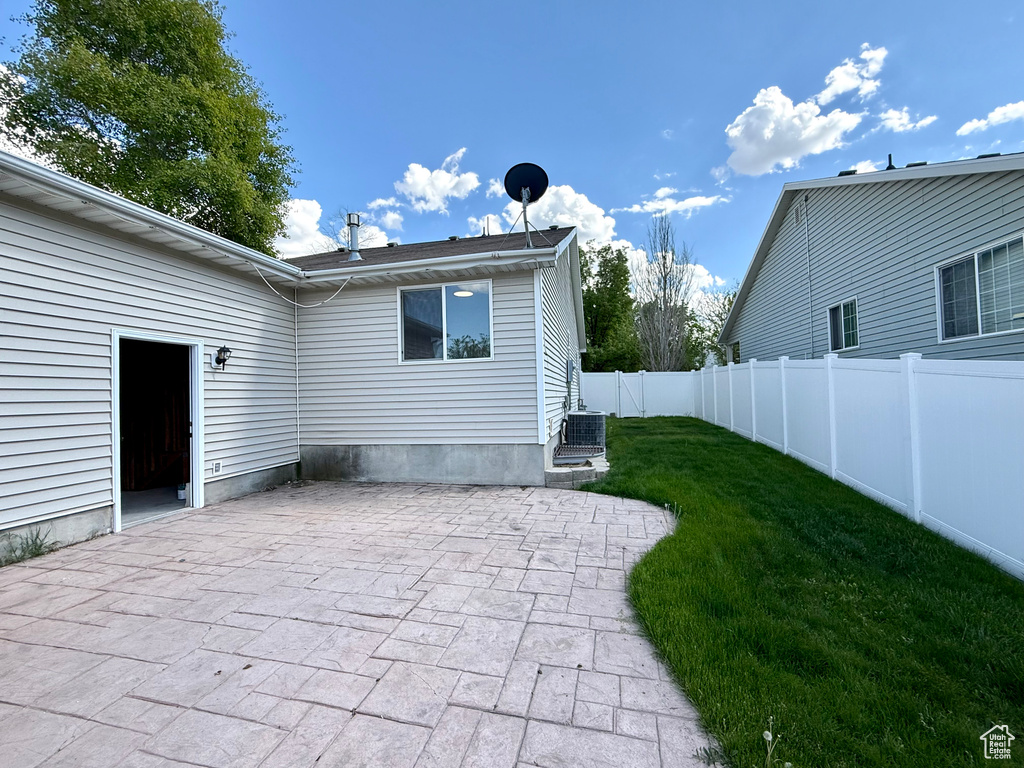 Rear view of property with a patio area and cooling unit