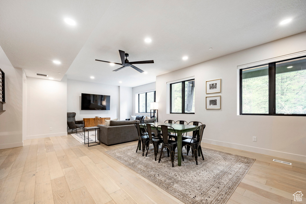 Dining area featuring baseboards, light wood finished floors, a ceiling fan, and recessed lighting