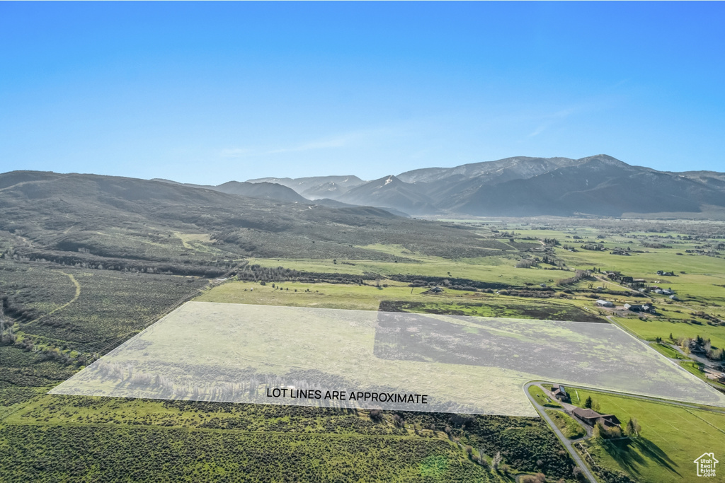 View of mountain backdrop with rural landscape