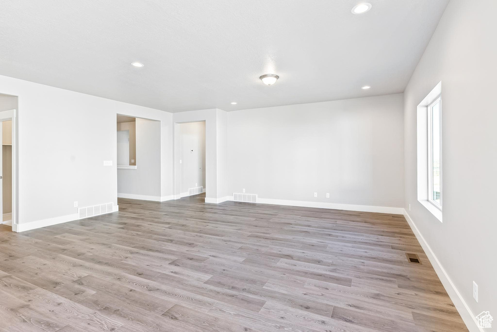 Unfurnished room featuring recessed lighting, light wood-type flooring, and baseboards