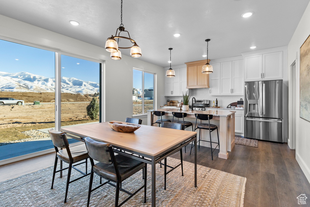 Dining space featuring recessed lighting, a mountain view, dark wood-style floors, and a chandelier