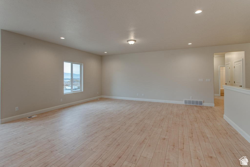 Spare room with light wood-type flooring, recessed lighting, and baseboards