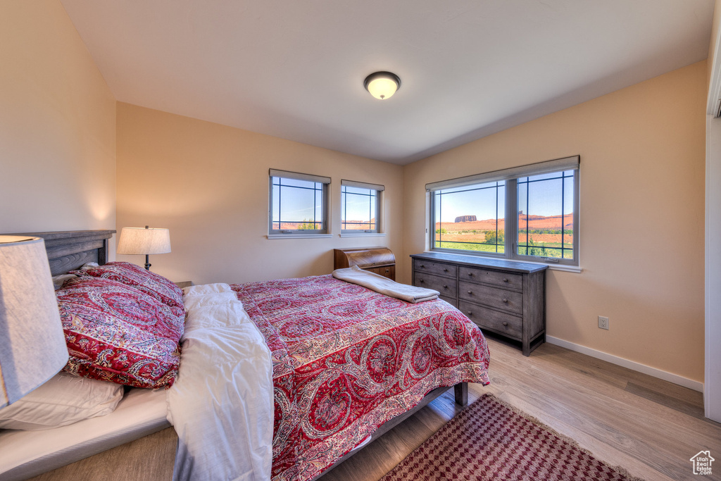 Bedroom with baseboards and light wood-style floors