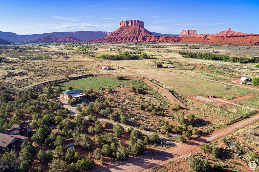 Aerial view of property's location featuring a mountainous background and rural landscape