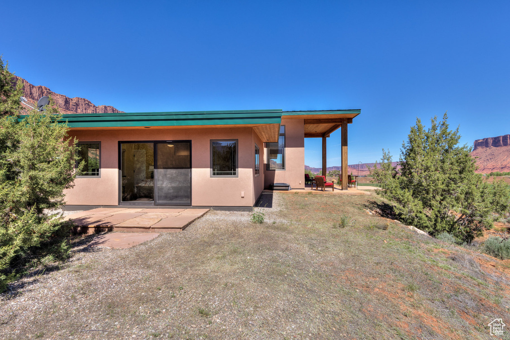 Rear view of property featuring a patio, stucco siding, and a mountain view