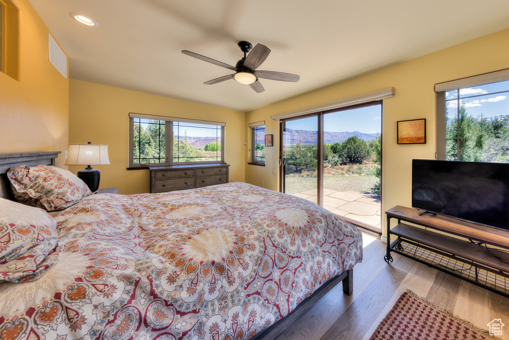 Bedroom featuring wood finished floors, access to outside, recessed lighting, and ceiling fan