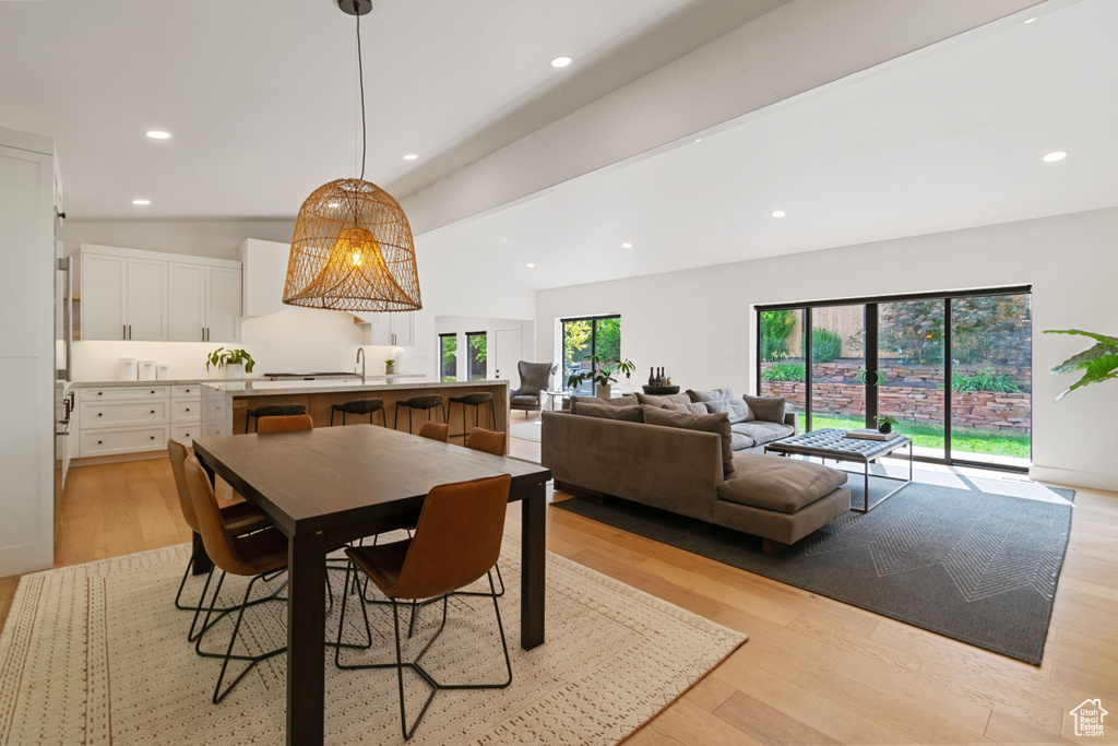 Dining room with light wood-style flooring and recessed lighting