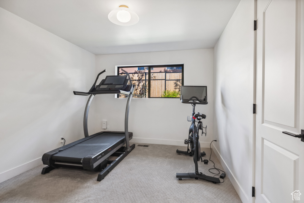 Workout room with carpet and baseboards