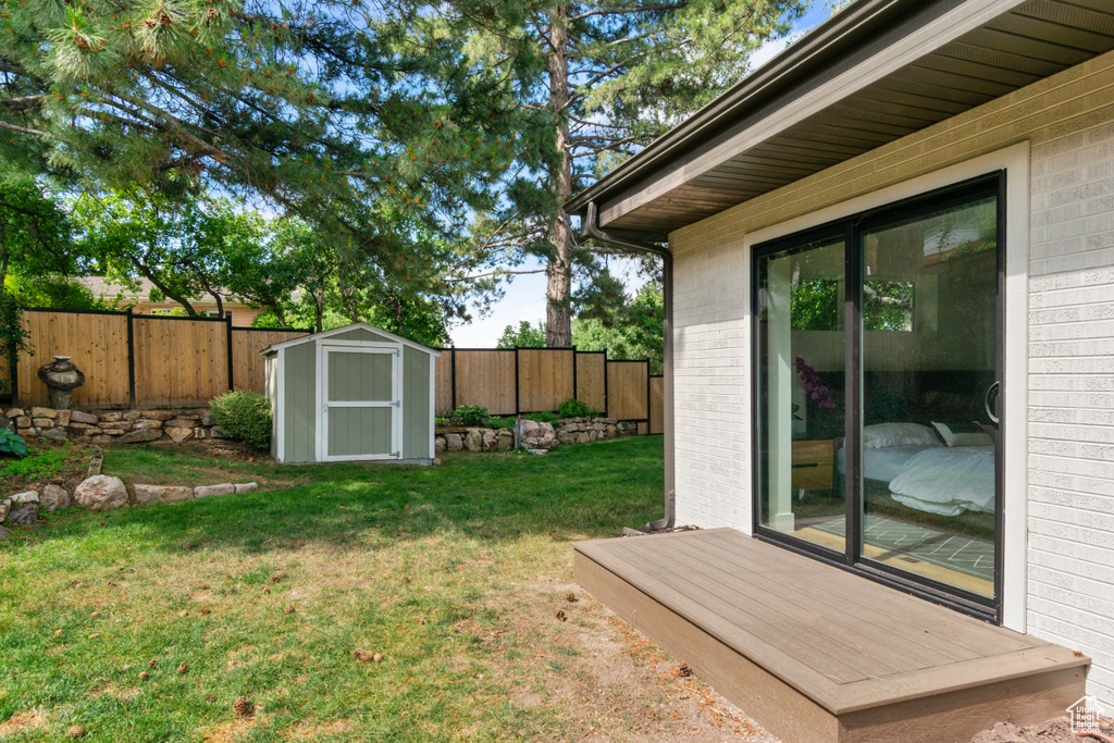 Fenced backyard with a storage shed