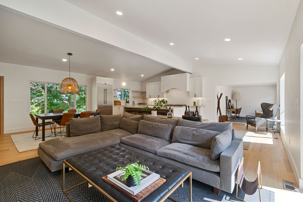 Living room with light wood-style floors and recessed lighting