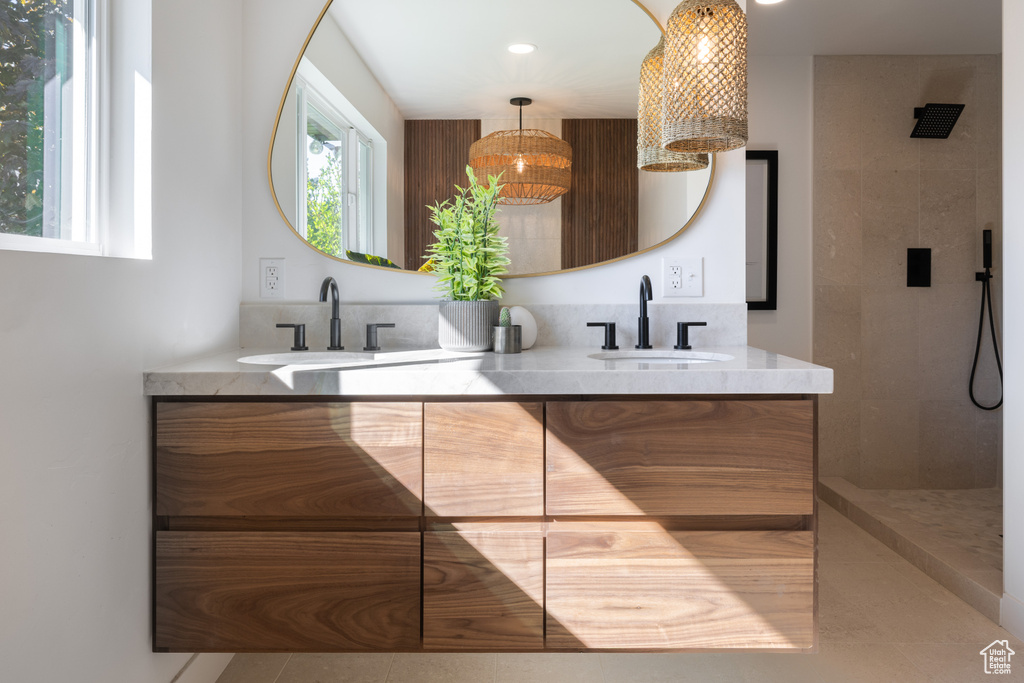 Kitchen with a sink, modern cabinets, light tile patterned floors, healthy amount of natural light, and recessed lighting