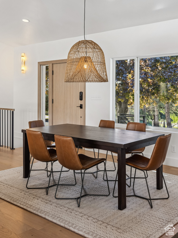 Dining room with light wood-type flooring and recessed lighting