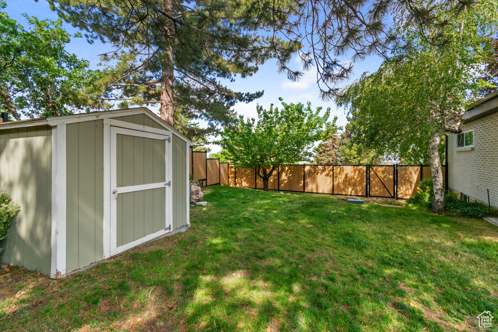Fenced backyard with a storage shed and a gate
